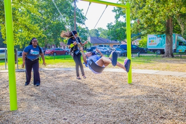 girls on the swingset smiling 