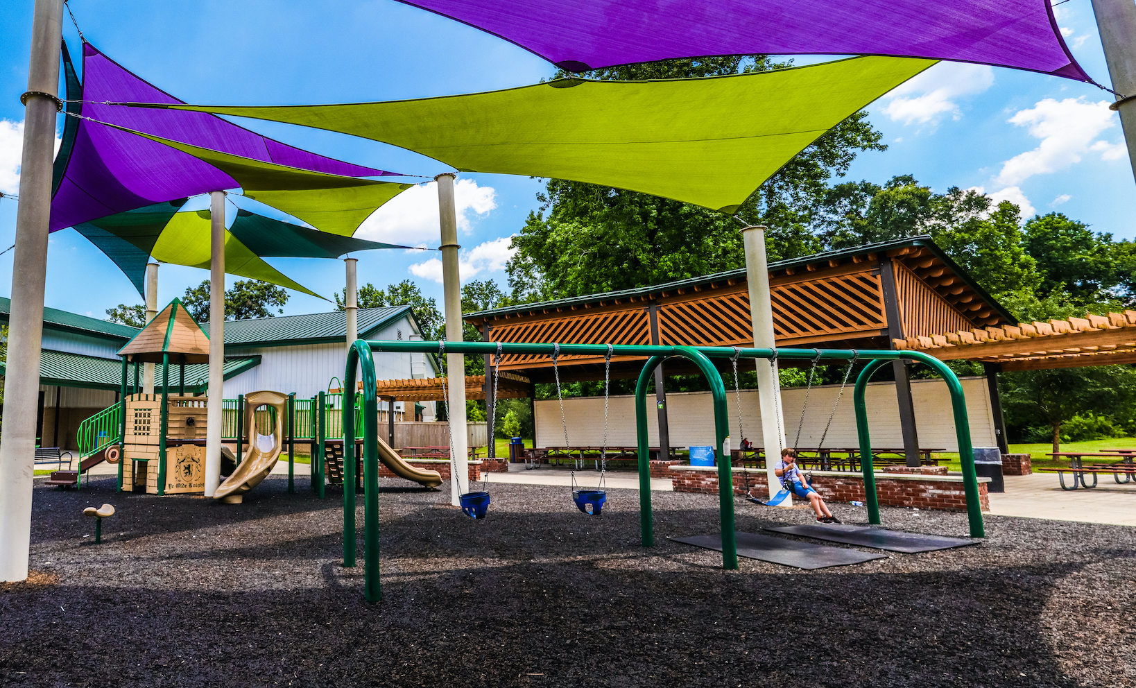 Children Playing On Playground In City Park Engaged In Football